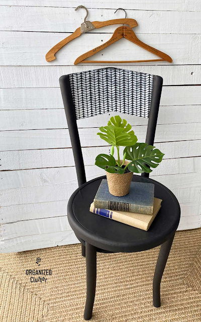 Photo of a vintage bentwood chair painted with Dixie Belle Chalk Paint in Caviar & stenciled with the Cozy Sweater stencil.