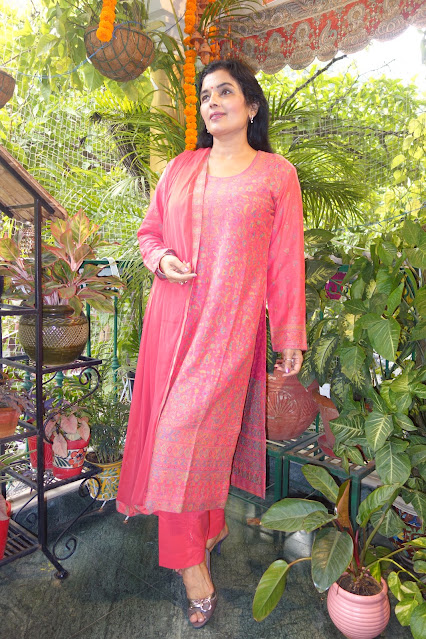 Carrot pink kani suit with dupatta. We have a range of these available. Check our website or WhatsApp us.