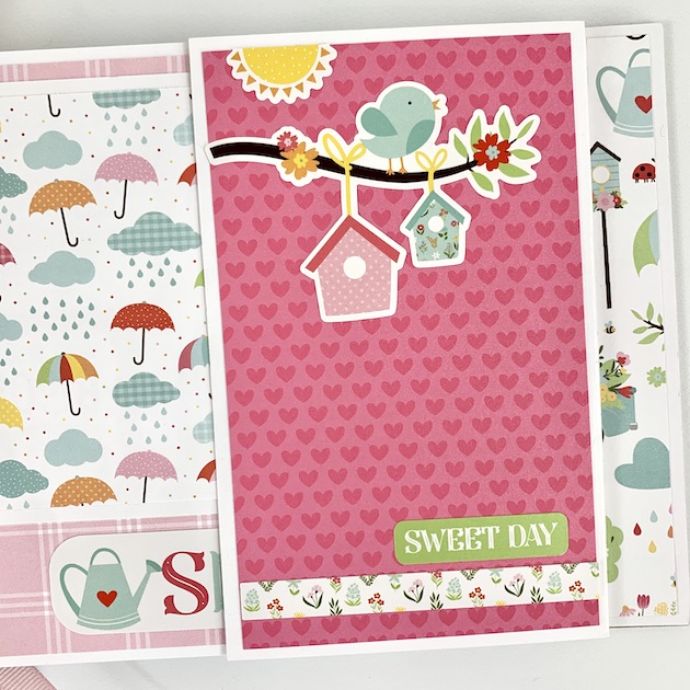 Spring scrapbook album page with bird, sun, umbrellas and folding page