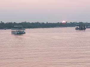 Sun finally setting over the Zambezi River .