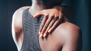 Woman holding her shoulder | Chiropractor Ann Arbor