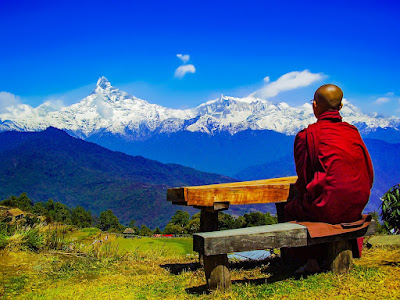 Monk sitting peacefully observing the landscape thinking