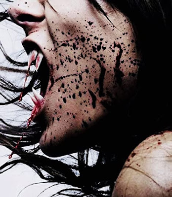 Amazing profile closeup of a woman with huge long fangs splattered with blood