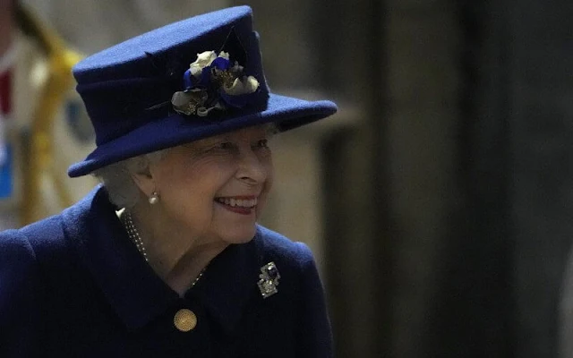 The Queen wore a navy blue coat, with a patterned dress. Queen Mary's Russian sapphire and diamond brooch