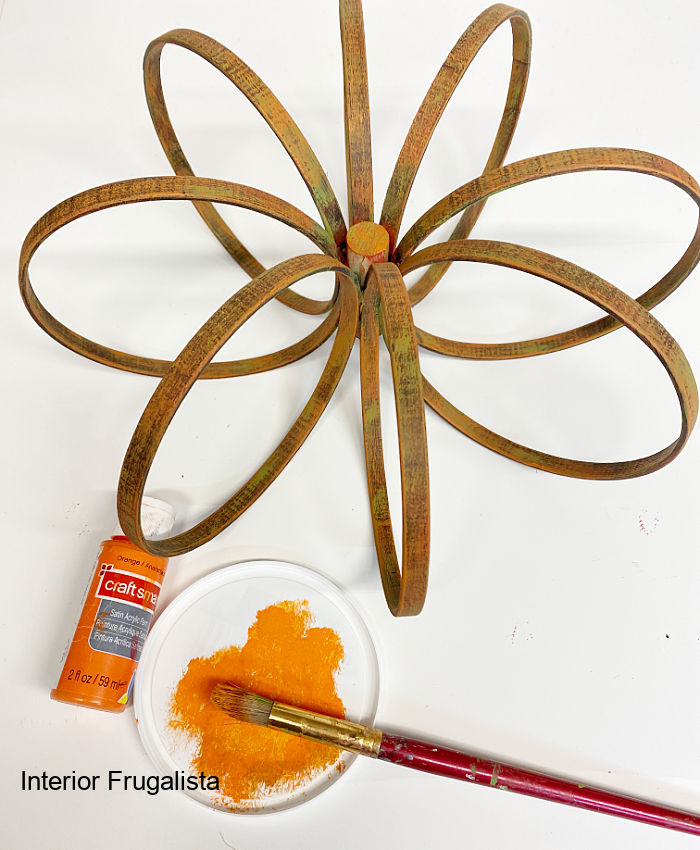 DIY embroidery hoop pumpkin with painted dry brushed layer of autumn orange.