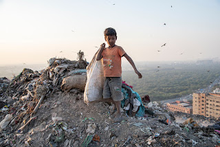 A boy in a Delhi landfill (India).