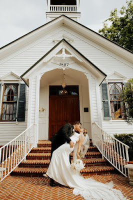 bride and groom kissing at chapel