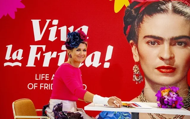 Queen Maxima wore a fuchsia blouse and floral print midi skirt from Natan. Mexican painter Frida Kahlo