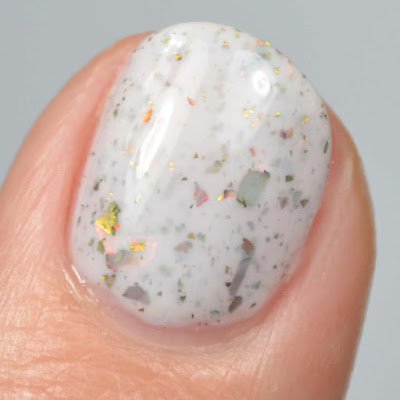 white crelly nail polish with flakies swatch