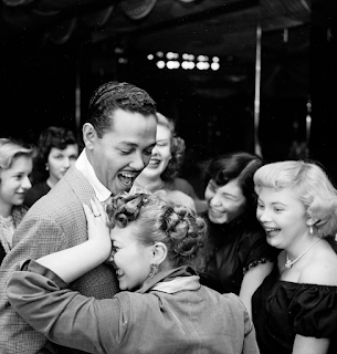 black and white photograph of Billy Eckstine being adored by female fans,New York, 1949