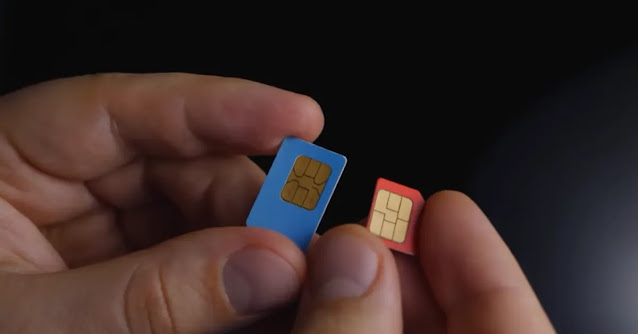 man holding two sim cards