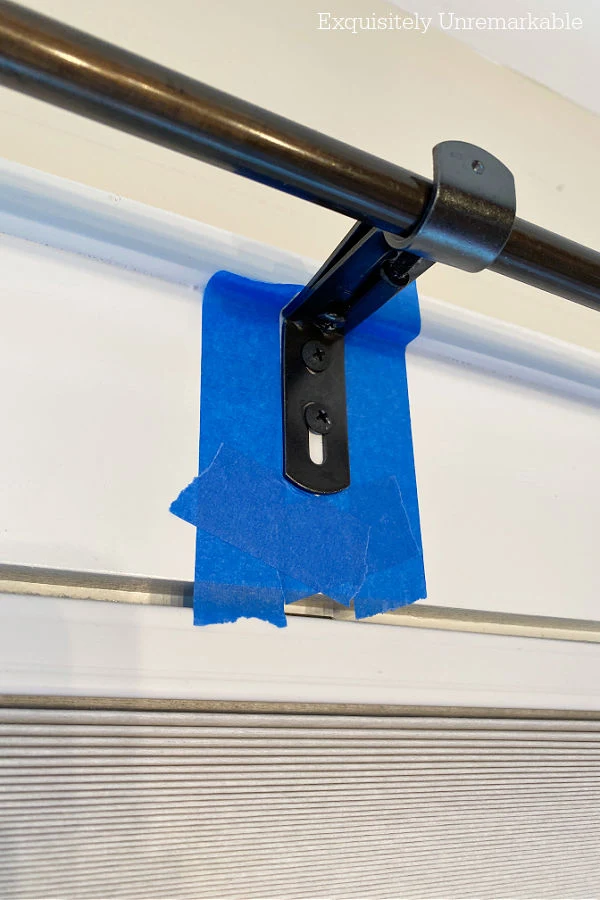 Metal Curtain Rod Center Bracket taped off with blue painter tape