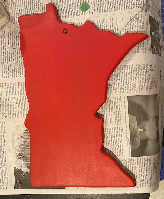 Photo of a Minnesota shaped cutting board painted red.