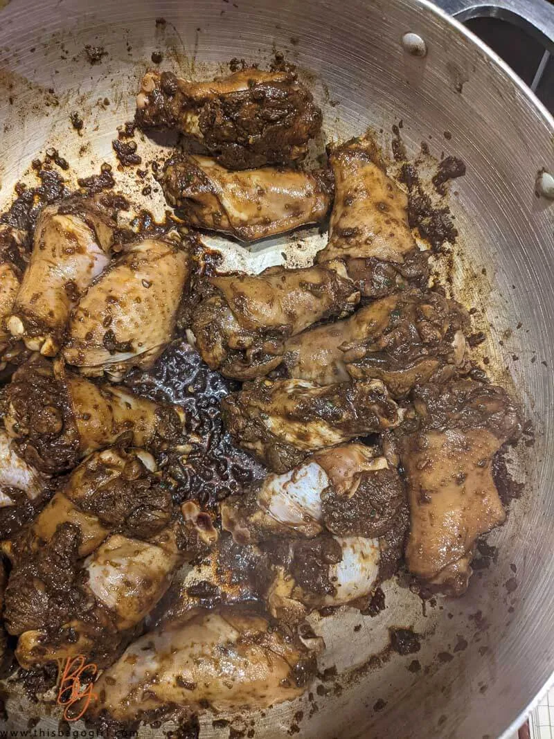 A picture of wings added to the caramelized sugar and combined.