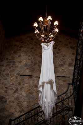 wedding gown hanging from chandelier at bella collina