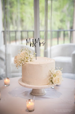 wedding cake with flowers and cake topper