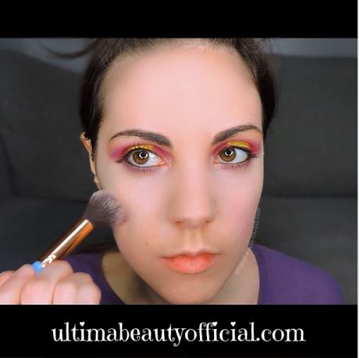 Ultima Beauty blending blush onto face