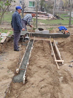 Putting cement in to the foundations