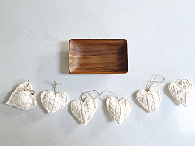 row of sweater hearts and wooden bowl