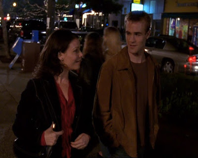 Amy and Dawson walking down the street and talking