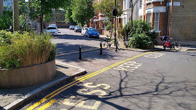 A model filter diagonally across a crossroads with planters and bollards to prevent driving.