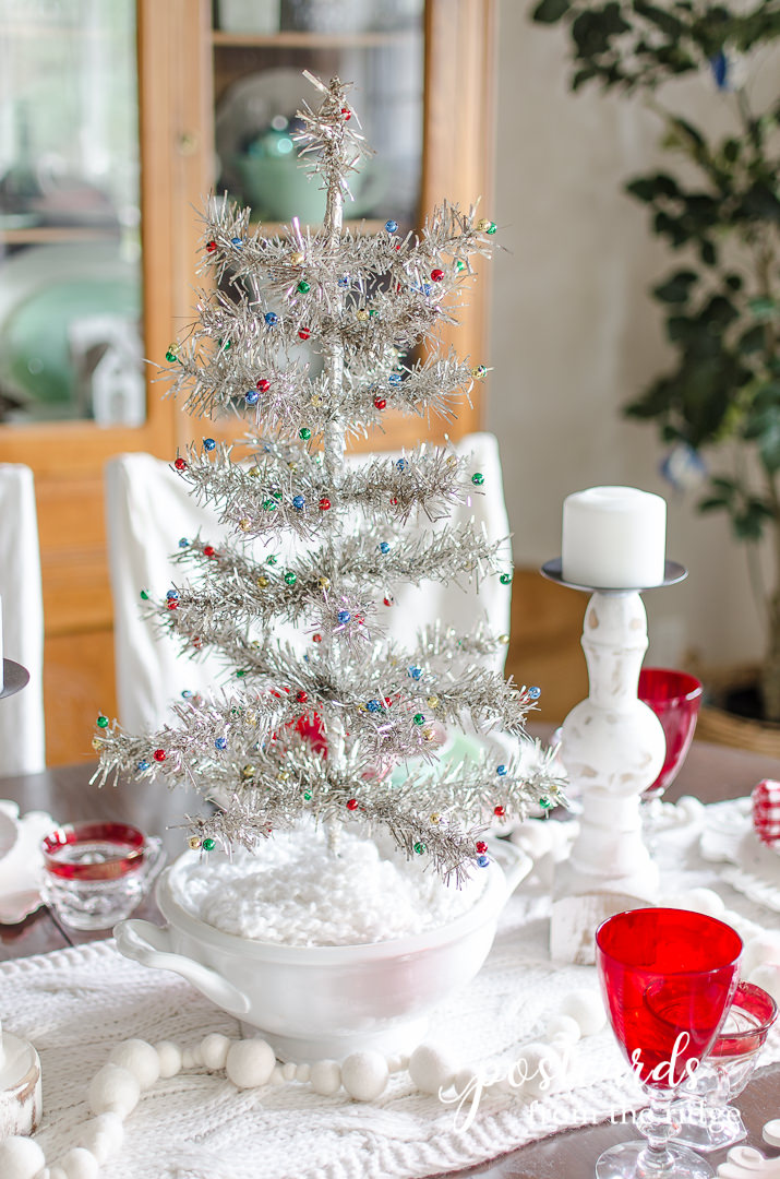 small tinsel tree in an ironstone soup tureen used as table decorations on a Christmas table