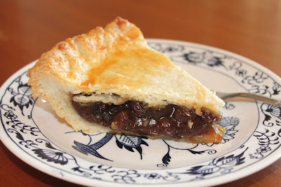 Side view of a slice of raisin pie.