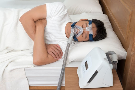 man wearing a cpap machine