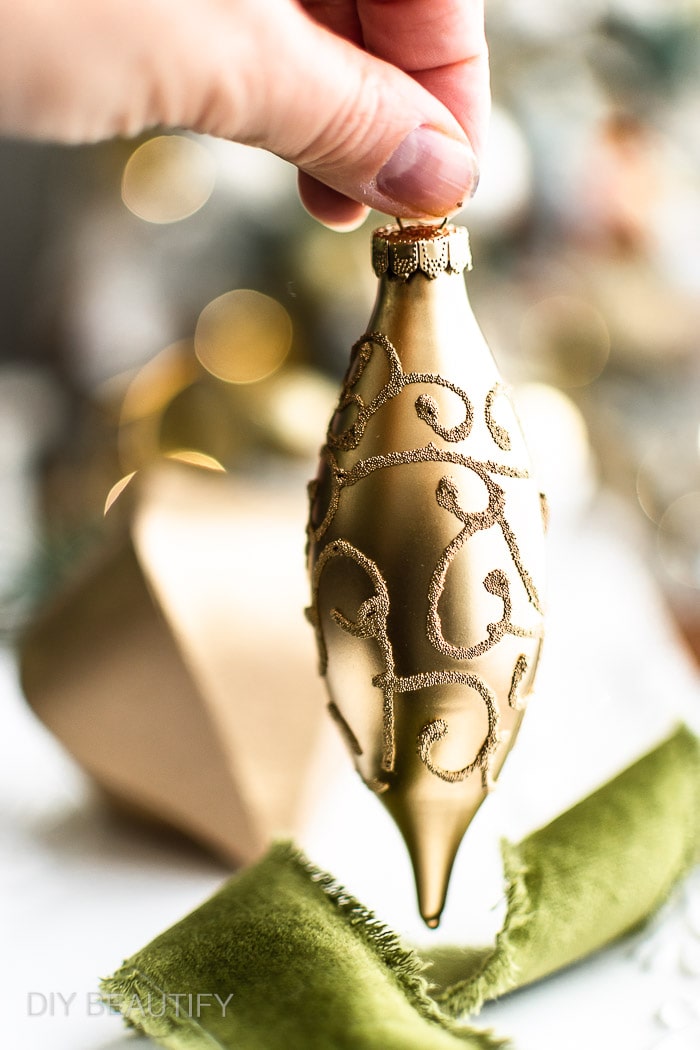 gold spray paint highlights texture on old glass ornament