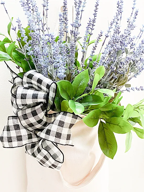 lavender in a tote with a buffalo check bow