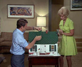 Mike and Carol fix a dollhouse in the den.