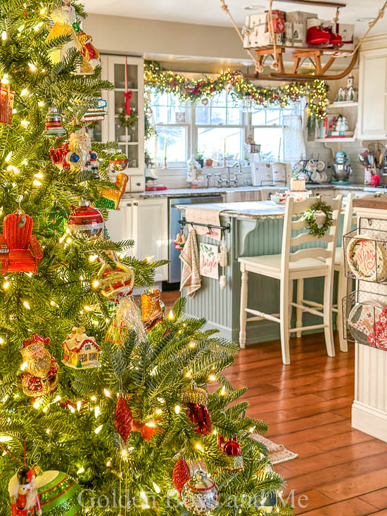 Christmas kitchen with country decor and vintage sled over kitchen island - www.goldenboysandme.com