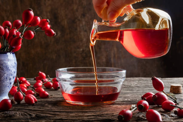 Pouring rosehip oil into a bowl