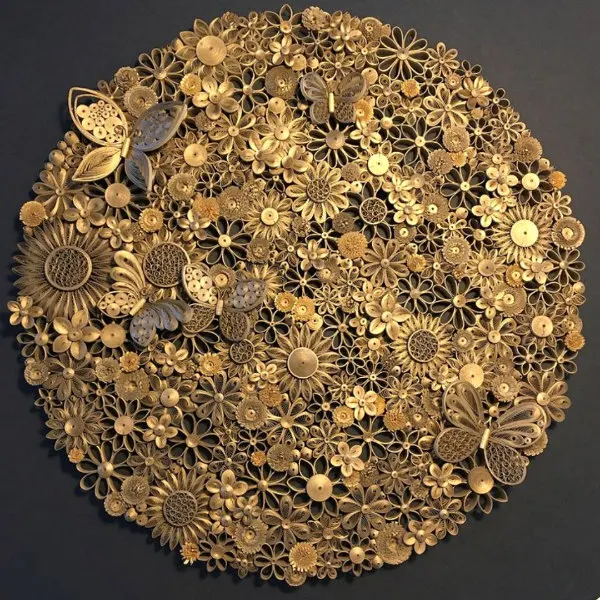 circular gilded quilled art piece composed of flowers and butterflies