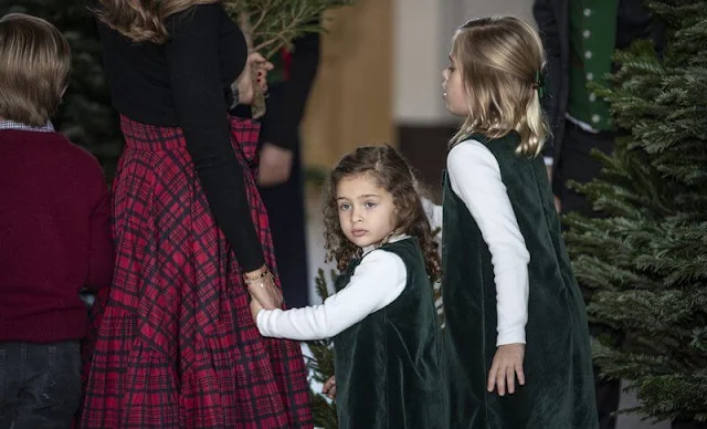 Princess Leonore and Princess Adrienne wore an emerald velvet pinafore dress by Trotters Kids. Chris O'Neill and Prince Nicolas