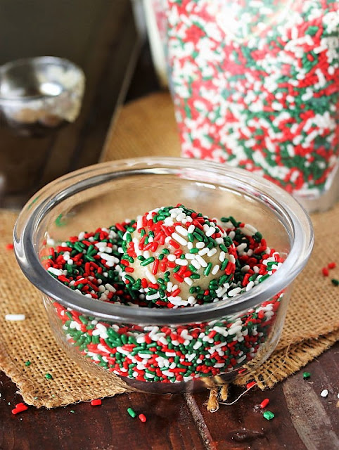 Rolling Sugar Cookie Dough Balls in Christmas Sprinkles Image