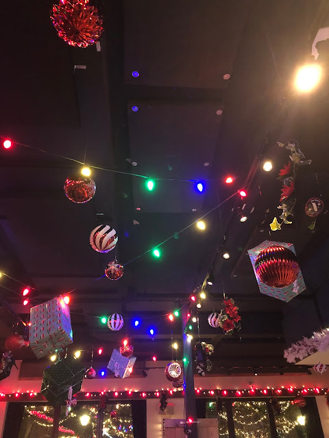 Christmas cheer dangles from the ceiling.