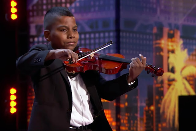 Tyler Butler is an 11-year-old boy. He comes to the Americas Got Talent stage with a violin in his hand. This cute black boy captivates the jury the moment he steps onto the stage. But some pain in his face. He reveals why when he was asked why he came to this competition.