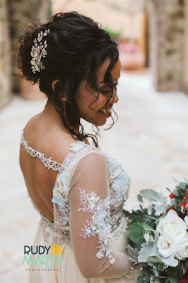 bride in lace dress smiling with flowers