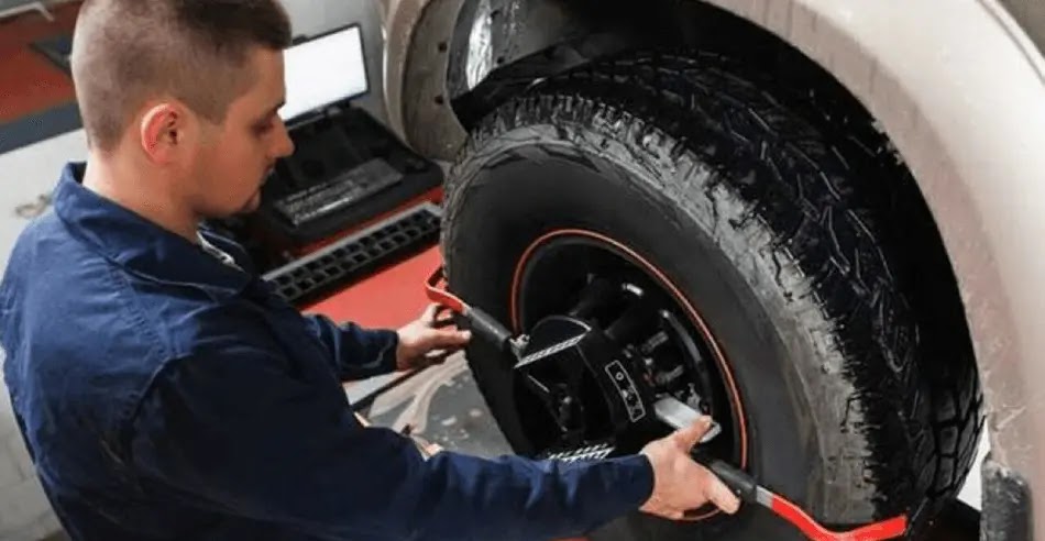 Mechanic performs a wheel adjustment