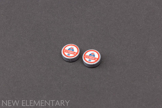2 silver lego round tiles printed with cobra logos