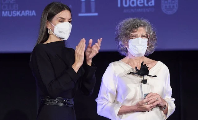 Queen Letizia wore a navy draped-neck ribbed wool dress from Cos. The Queen wore snakeskin embossed pumps from Manolo Blahnik