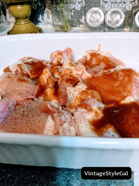 Raw chicken in baking dish with sauce over it