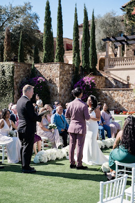 bride and groom during ceremony holding hands