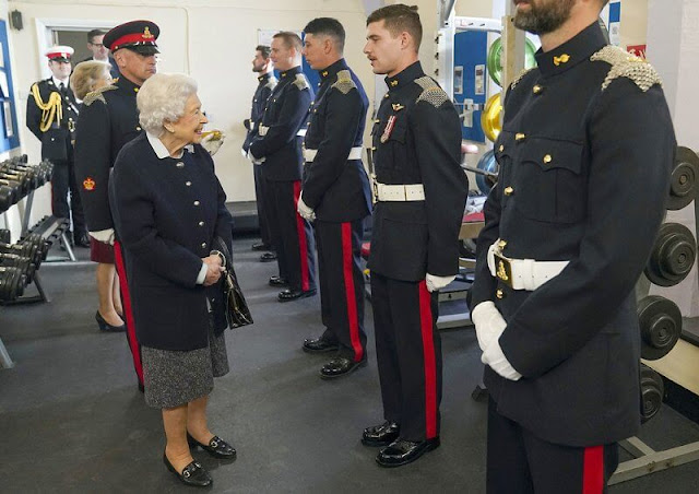 Queen Elizabeth wore a navy jacket over a blue shirt and a tweed skirt, accesorising with the Canadian diamond maple leaf brooch
