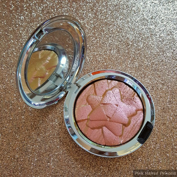 silver compact open with mirror inside and pink yellow green limited edition highlighting powder