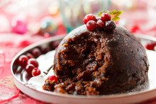 Illustrative photo of a Christmas pudding with a piece scooped out