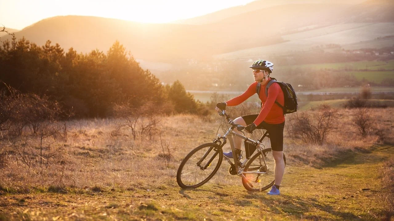 Mountain biker wearing red long sleeve sweatshirt.