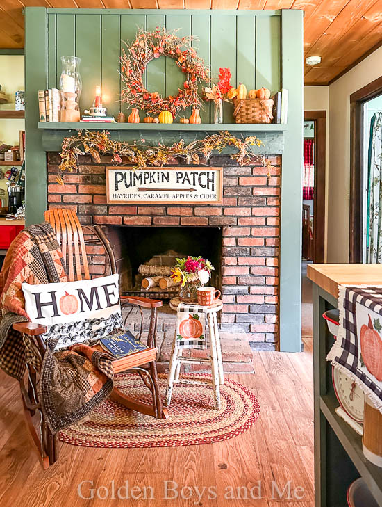 Fireplace in cabin kitchen with fall decor - www.goldenboysandme.com