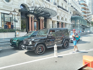 The who's who of ultra luxury cars passing alongside Hotel de Paris in Monaco.